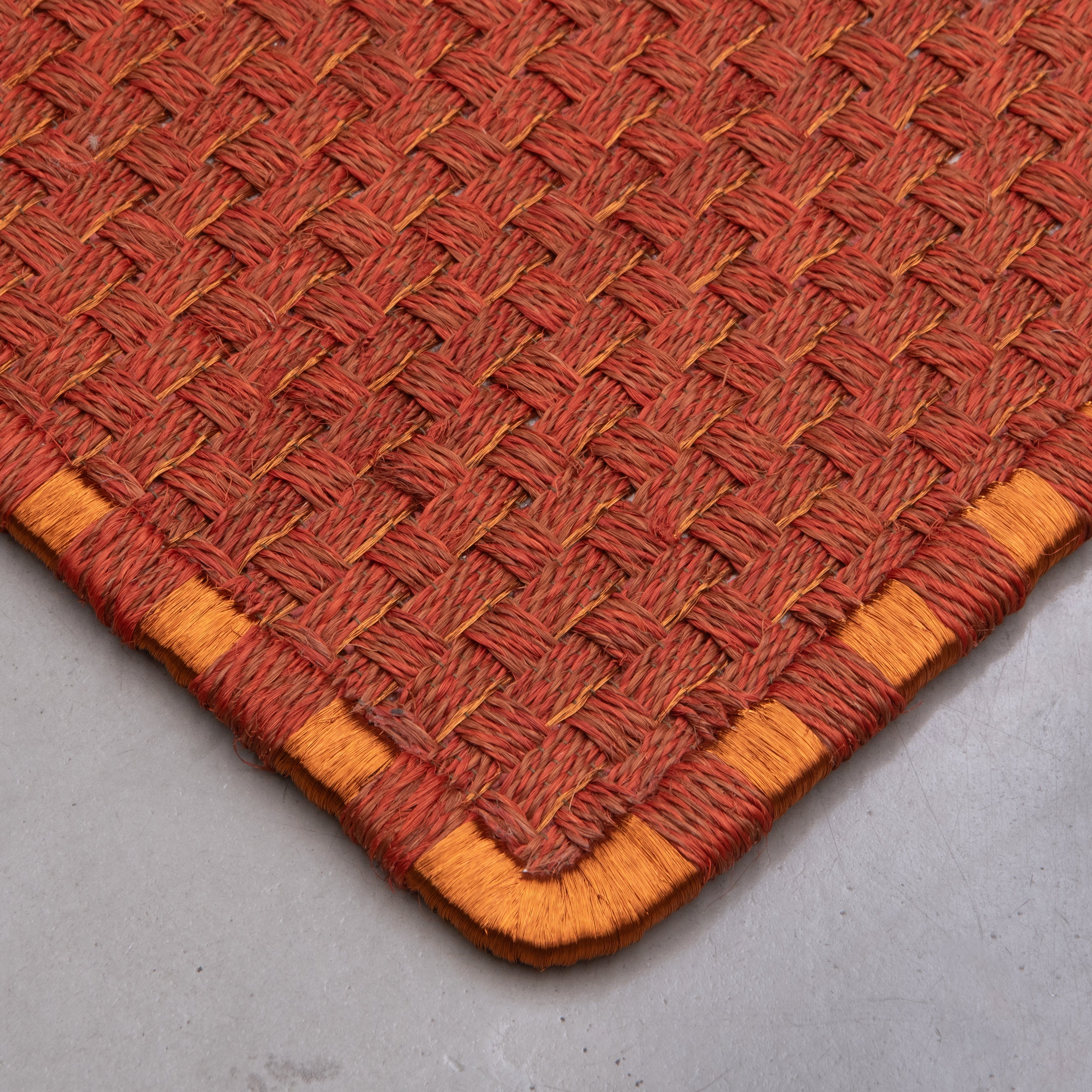 KANASPI WEAVE RUG IN OCHRE AND BURGUNDY FIQUE FIBER AND COPPER