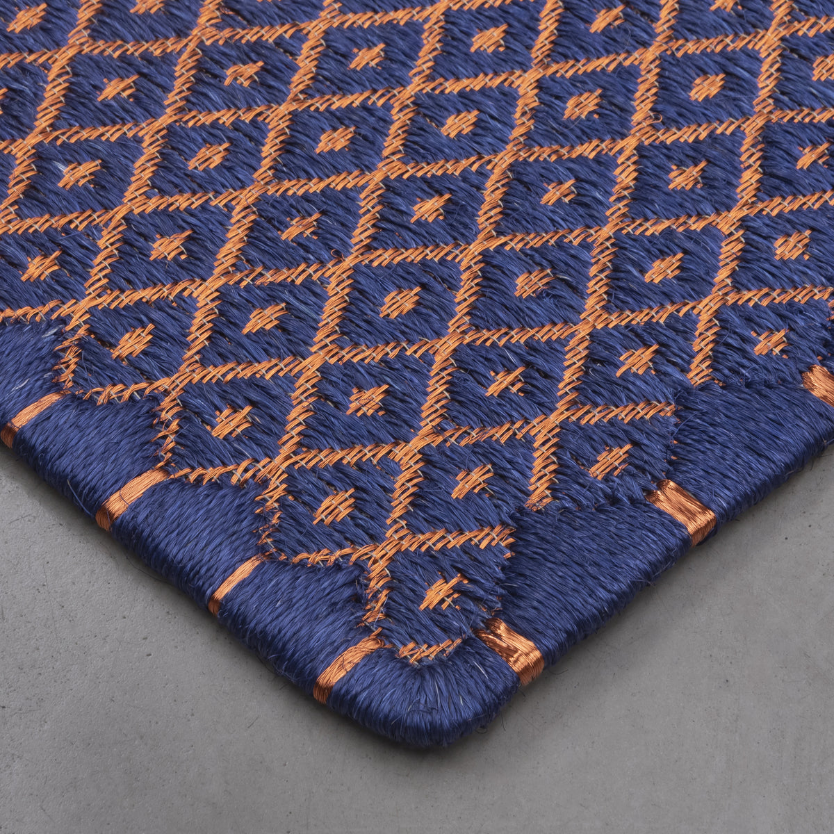 RHOMBUS WEAVE RUG IN ROYAL BLUE FIQUE FIBER WITH COPPER