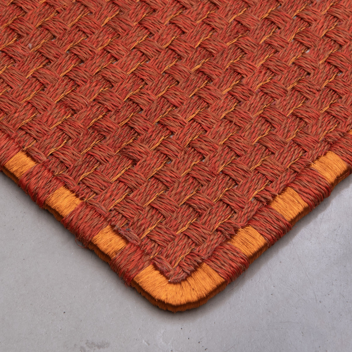 KANASPI WEAVE RUG IN OCHRE AND BURGUNDY FIQUE FIBER AND COPPER